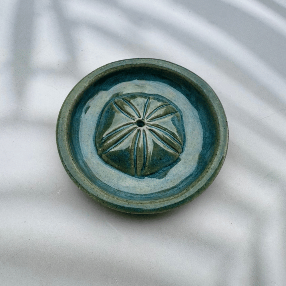 Ceramic dish with decorative pattern on a textured white background
