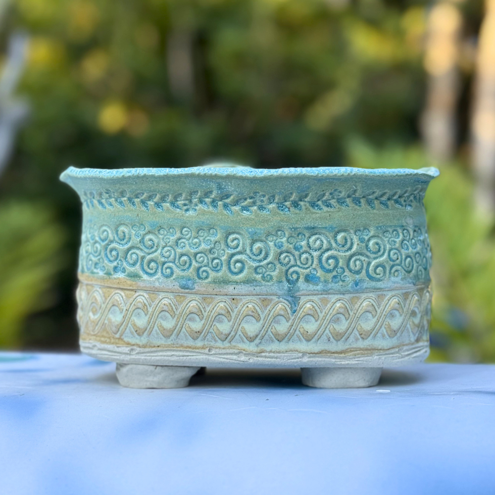 Handmade succulent pot with feet and floral applique