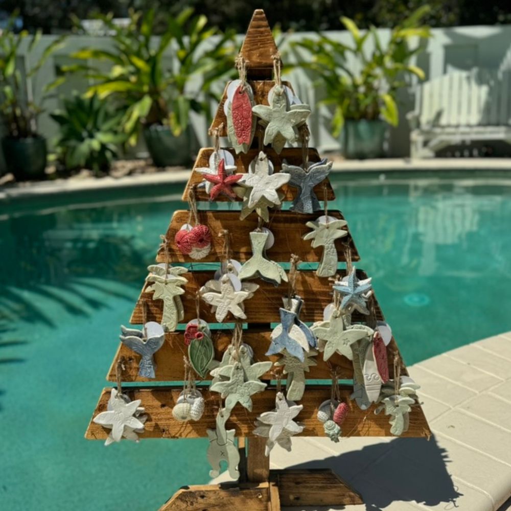 Decorative Christmas tree with ornaments by a poolside