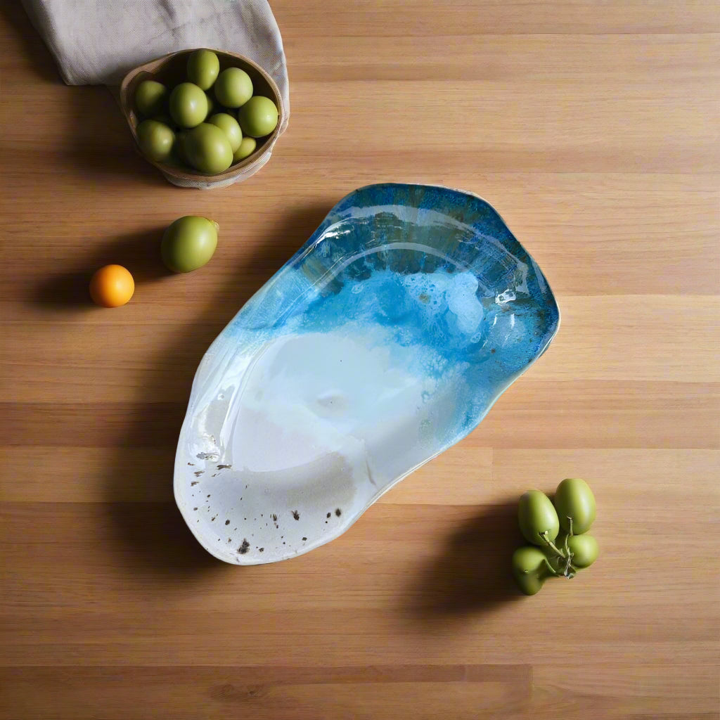 Blue and white shell on a bed of small stones