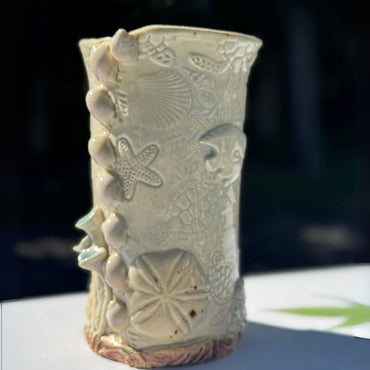 Ocean Shells Ceramic Vase with detailed sea-inspired textures including starfish, shells, and coral in a soft seafoam glaze. Ideal for coastal home decor.