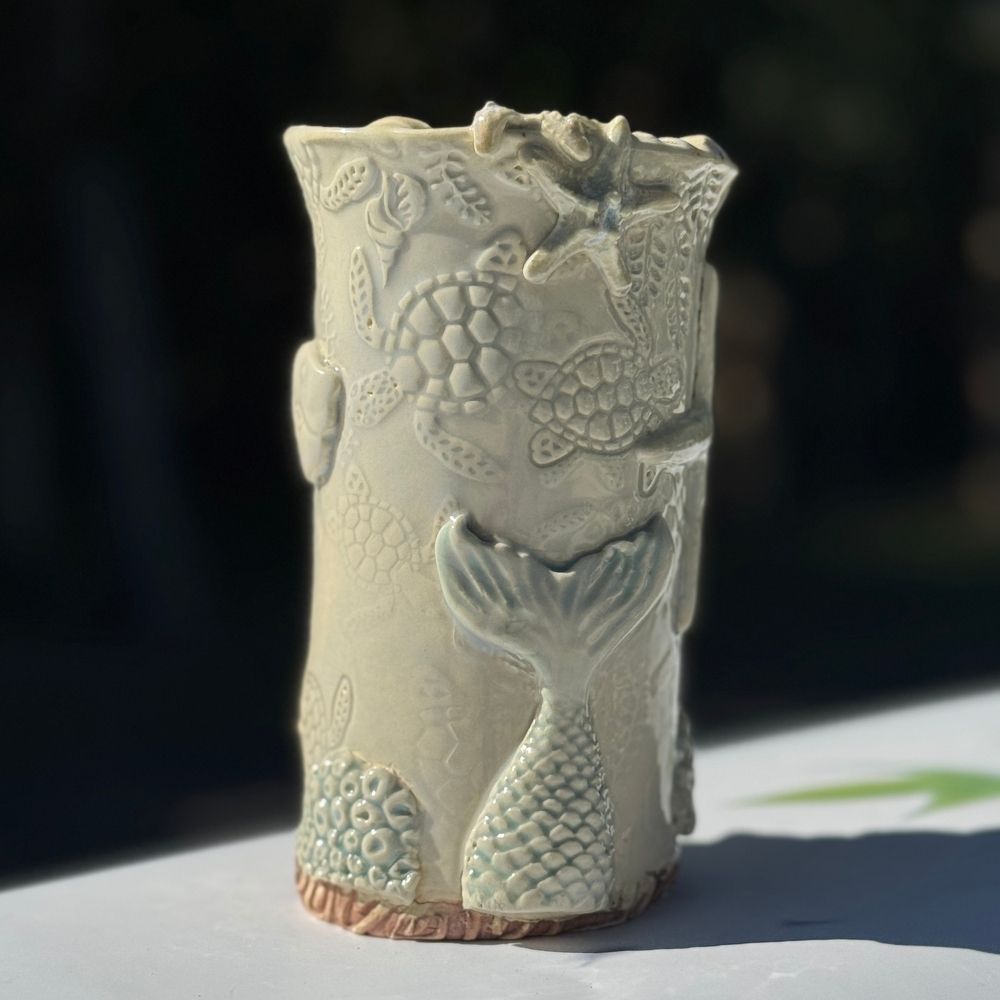 Ocean Shells Ceramic Vase with detailed sea-inspired textures including starfish, shells, and coral in a soft seafoam glaze. Ideal for coastal home decor.