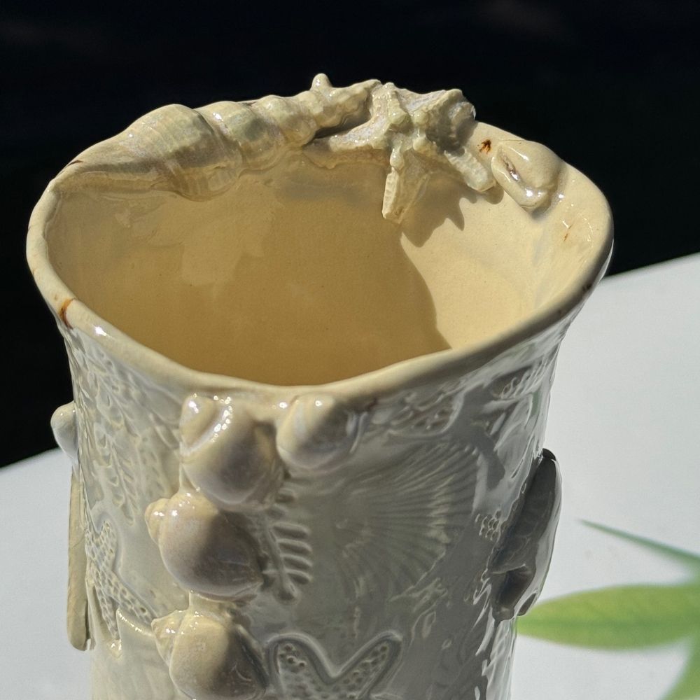 Ocean Shells Ceramic Vase with detailed sea-inspired textures including starfish, shells, and coral in a soft seafoam glaze. Ideal for coastal home decor.