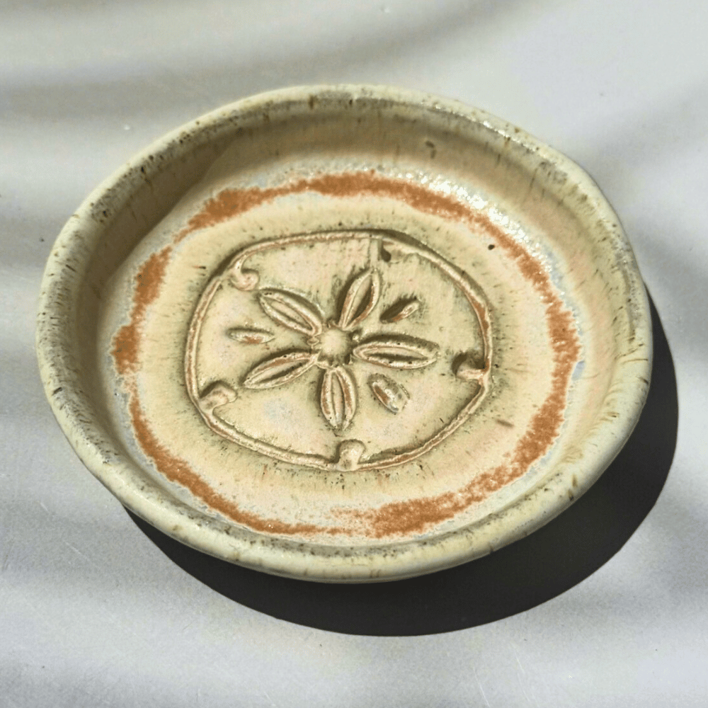 Ceramic ring dish with floral design on a white background