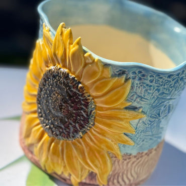 Sky Blue Sun-Kissed Sunflower Planter with 3D golden sunflower and textured ceramic body in sky blue and warm earth tones, ideal for garden decor. Hand-Made Sunshine Pot-Tree