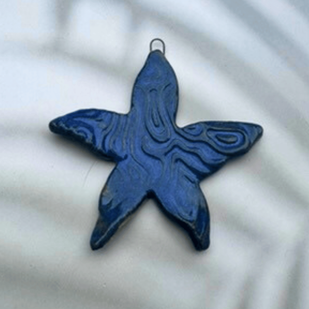 Blue starfish-shaped ornament on a white background