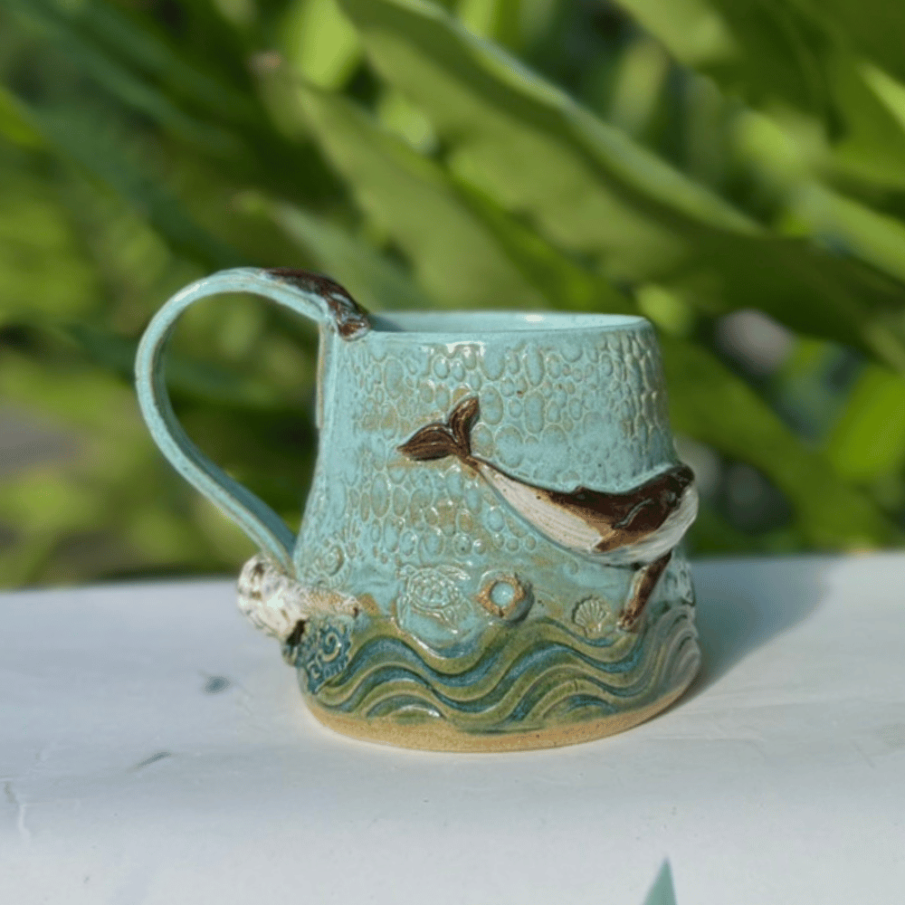 Ceramic mug with whale design on a white surface Sunshine Coast handmade gifts