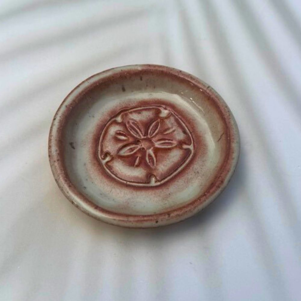 Small ceramic plate with a floral design on a white background