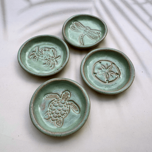 Four ceramic trinket dishes with embossed animal designs on a light background. Sunshine Pot-Tree