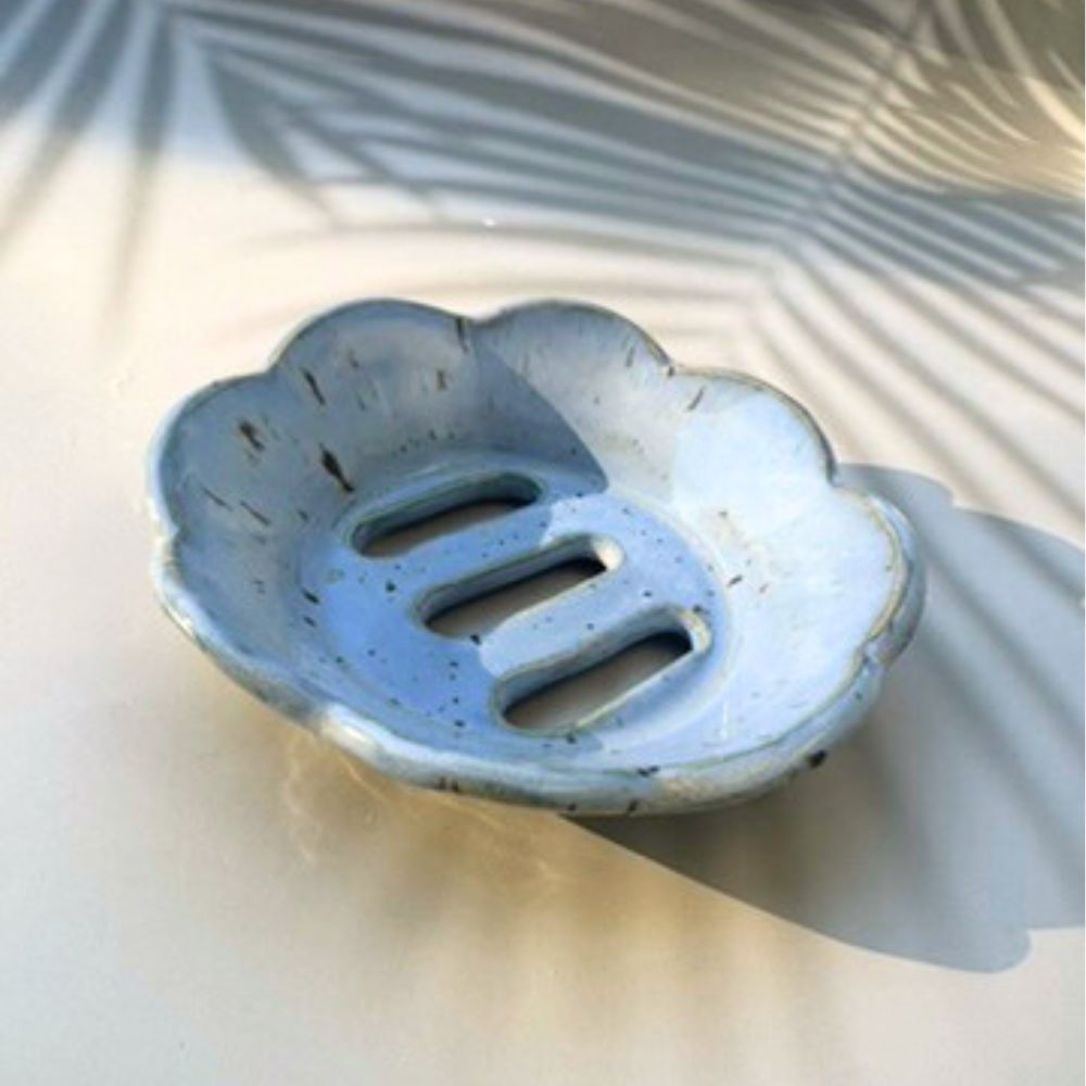 Blue ceramic soap dish on a light background