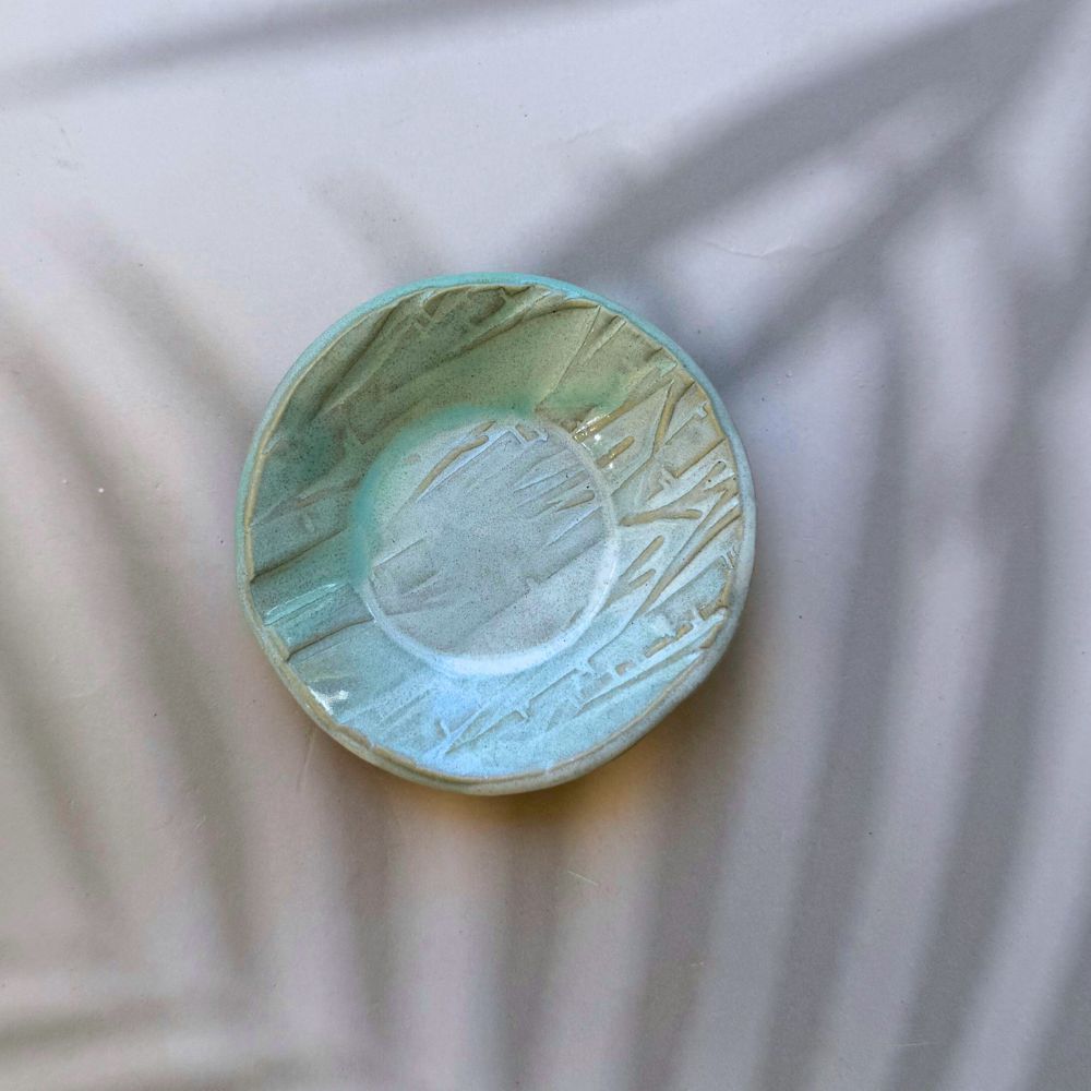 Ceramic bowl with textured surface on a light background. Sunshine Pot-Tree