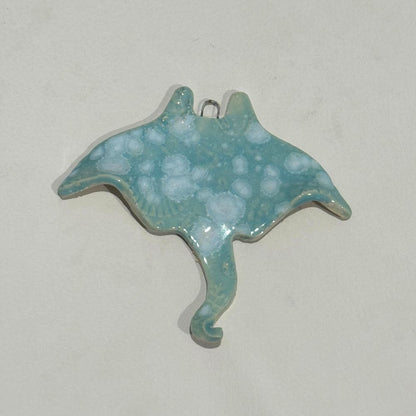 Turquoise ceramic stingray pendant on a light gray background