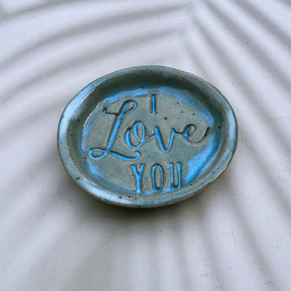 Ceramic trinket dish with 'I Love You' text on a textured surface
