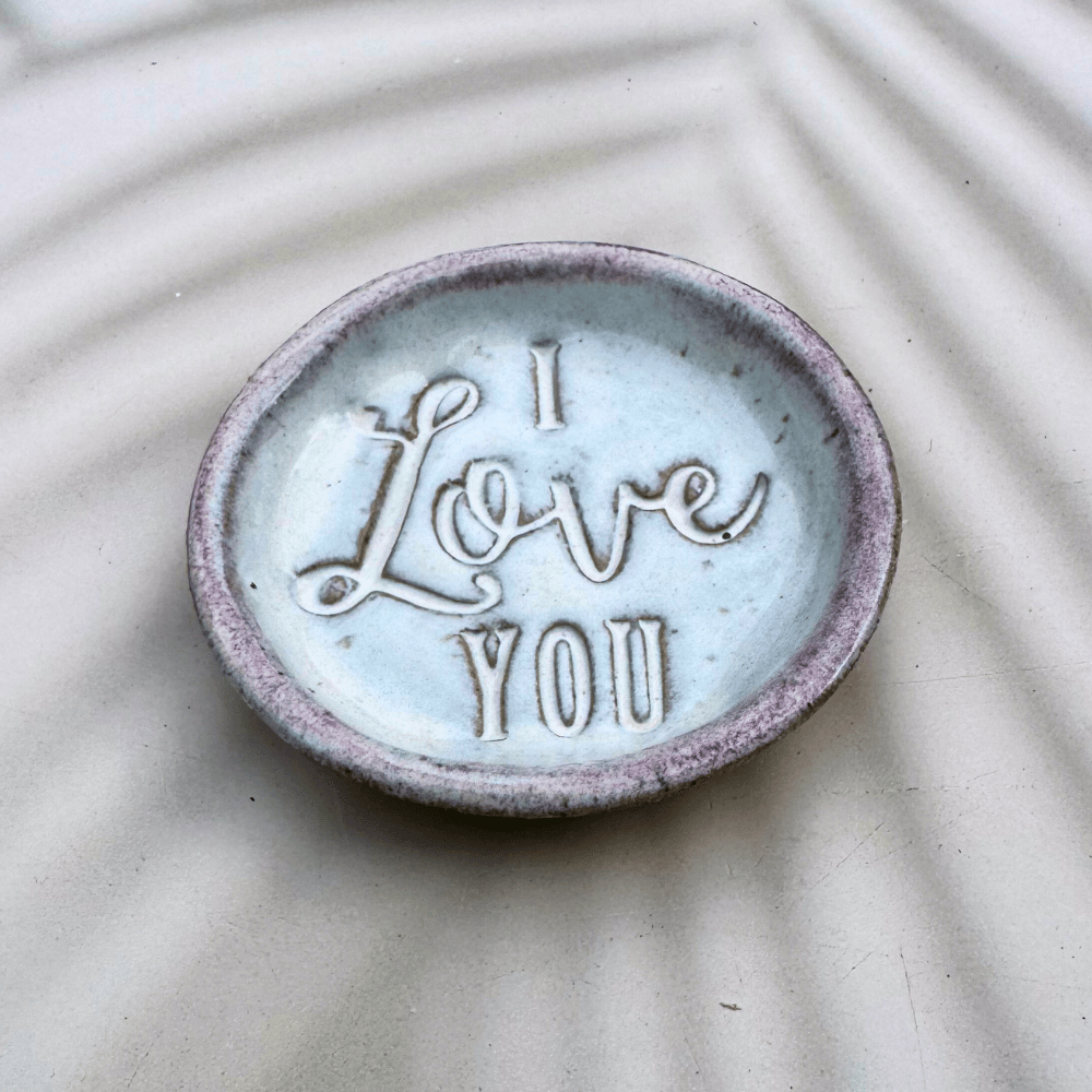 Ceramic dish with 'I Love You' text on a textured surface