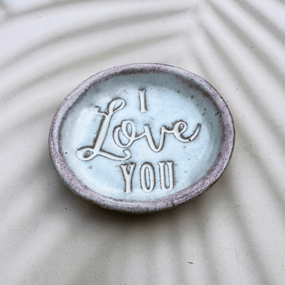 Ceramic dish with 'I Love You' text on a textured surface