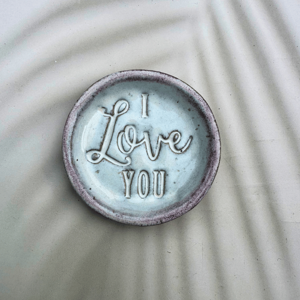 Ceramic ring dish with 'I Love You' text on a textured surface
