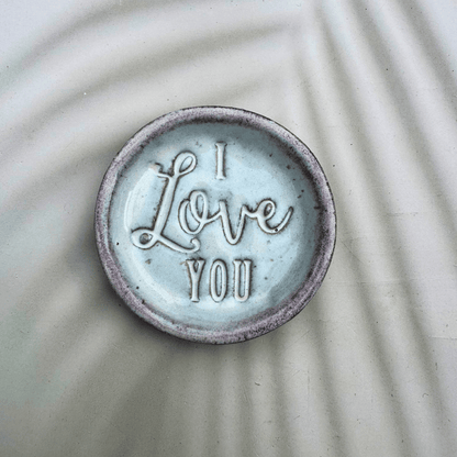 Ceramic ring dish with 'I Love You' text on a textured surface