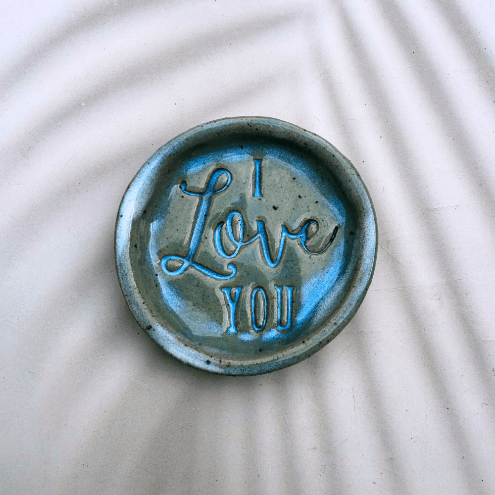 Ceramic ring dish with 'I Love You' text on a textured white background