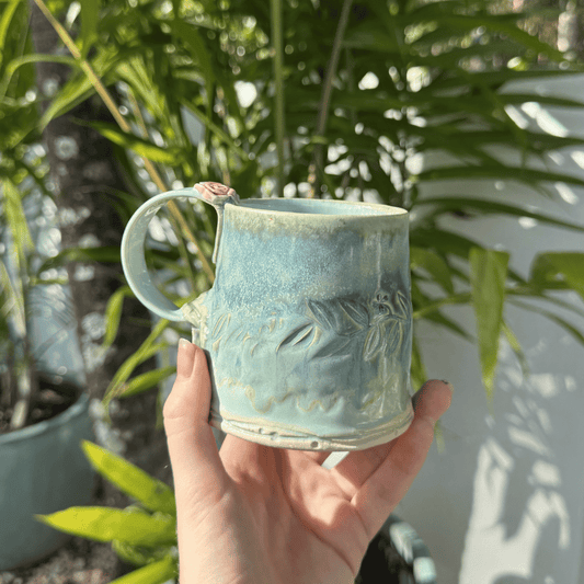 artisan pottery mug green glaze floral handle