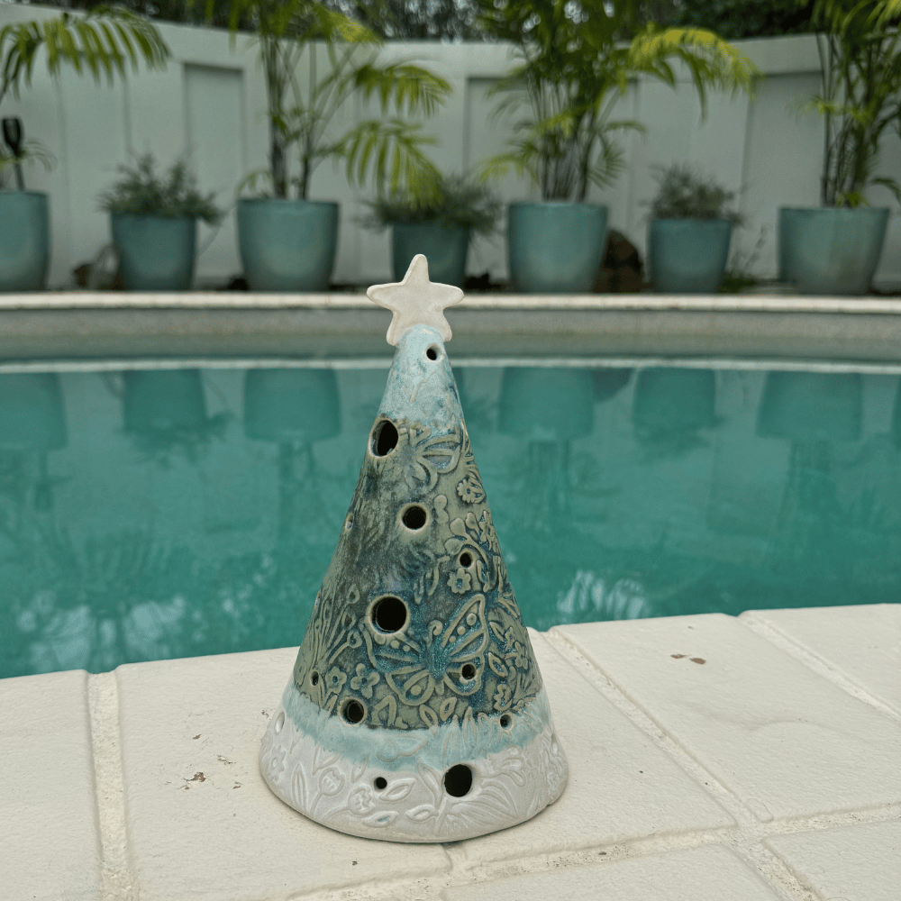 Decorative ceramic cone with star on top by a pool