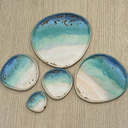 Set of ceramic dishes with blue and white glaze on a wooden surface
