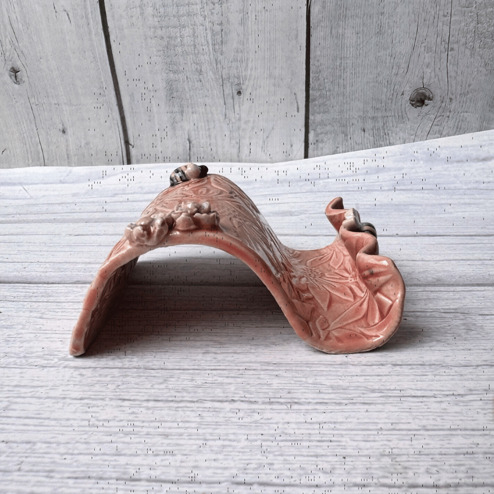 Ceramic business card holder with floral and bee patterns on a wooden surface
