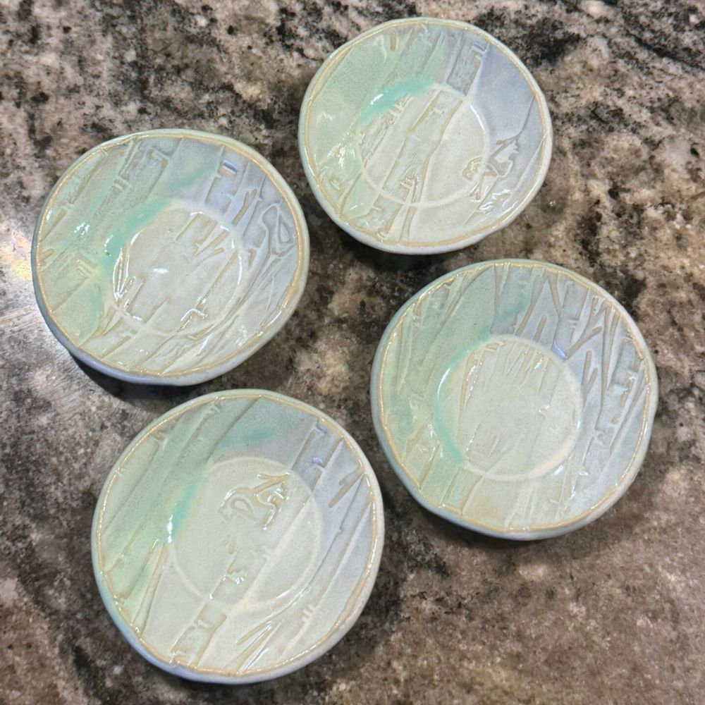 Ceramic ring dishes with embossed design on a textured beige background. Sunshine Pot-Tree