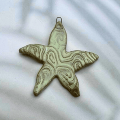 Decorative starfish pendant on a light background